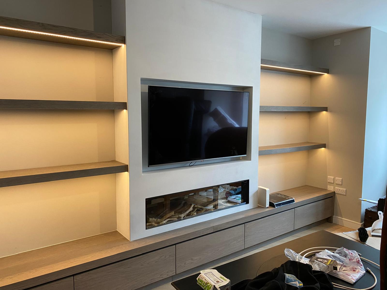 Media wall with stylish shelving lighting